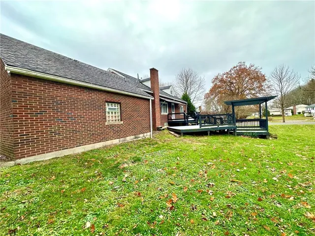 a view of empty room with wooden walls