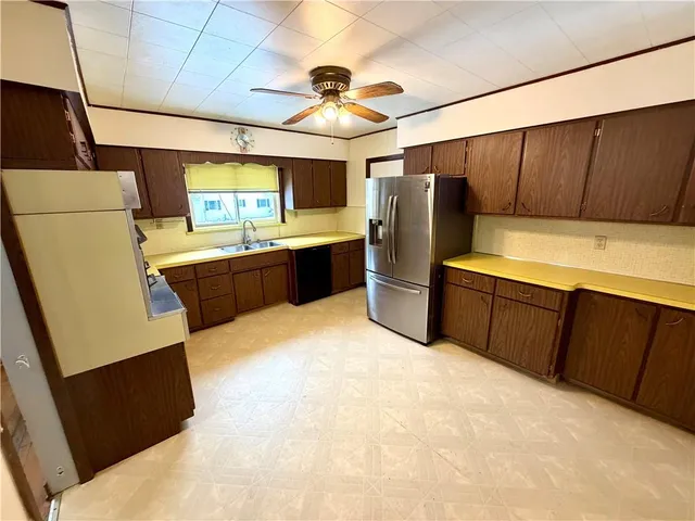 a kitchen with stainless steel appliances a refrigerator and a microwave