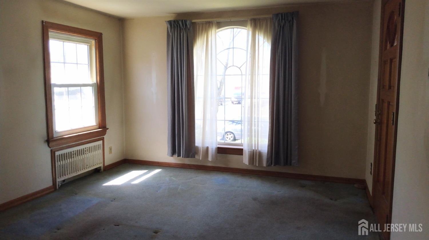 311 Hillside Road Linden, NJ 07036 - Photo 5 of 13 an empty room with windows