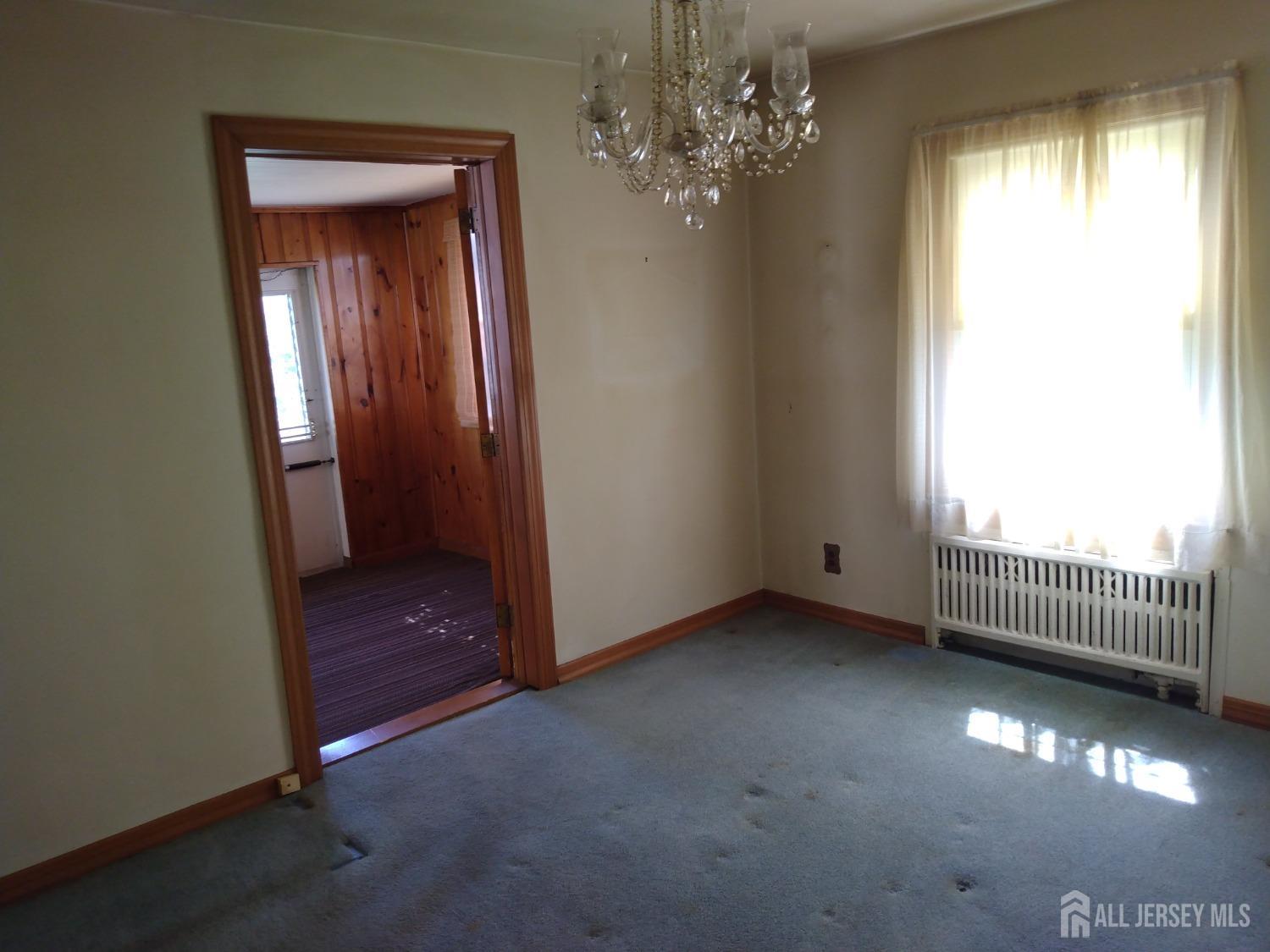 311 Hillside Road Linden, NJ 07036 - Photo 7 of 13 wooden floor in an empty room with a window