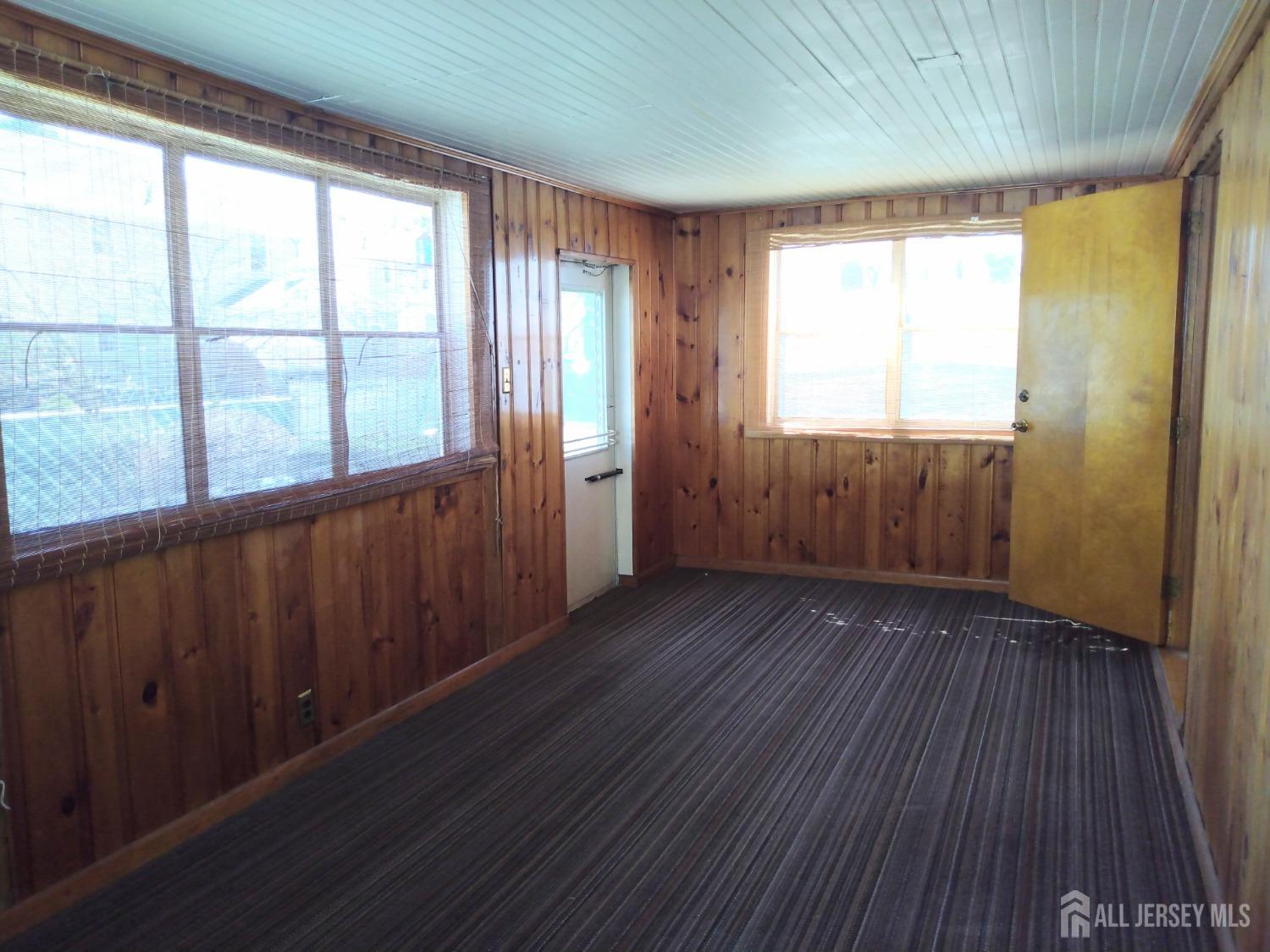 311 Hillside Road Linden, NJ 07036 - Photo 8 of 13 a view of an empty room with wooden floor and a window