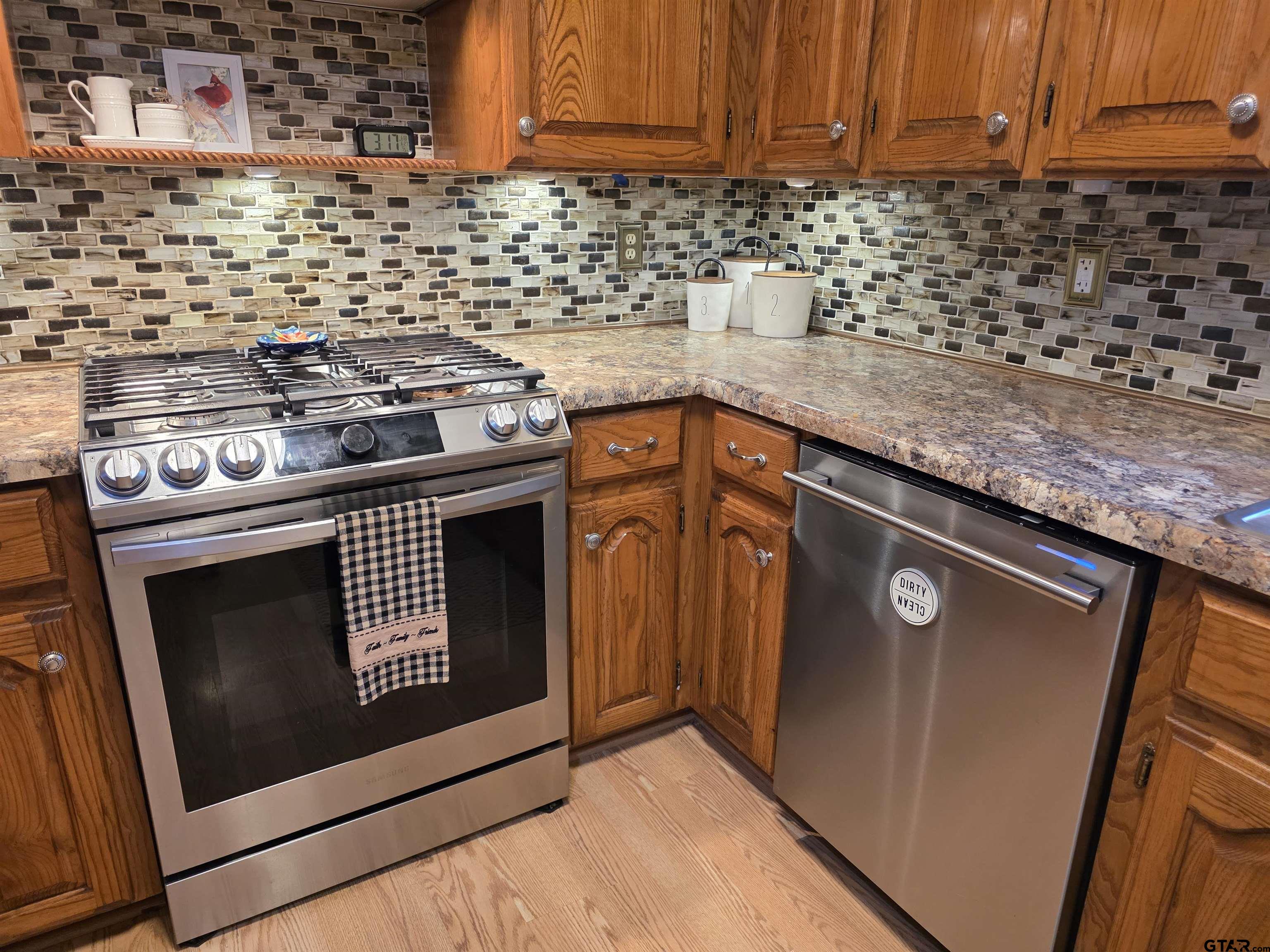 6170 Highway 271 Mount Pleasant, TX 75455 - Photo 17 of 43 a kitchen with granite countertop stove top oven and cabinets