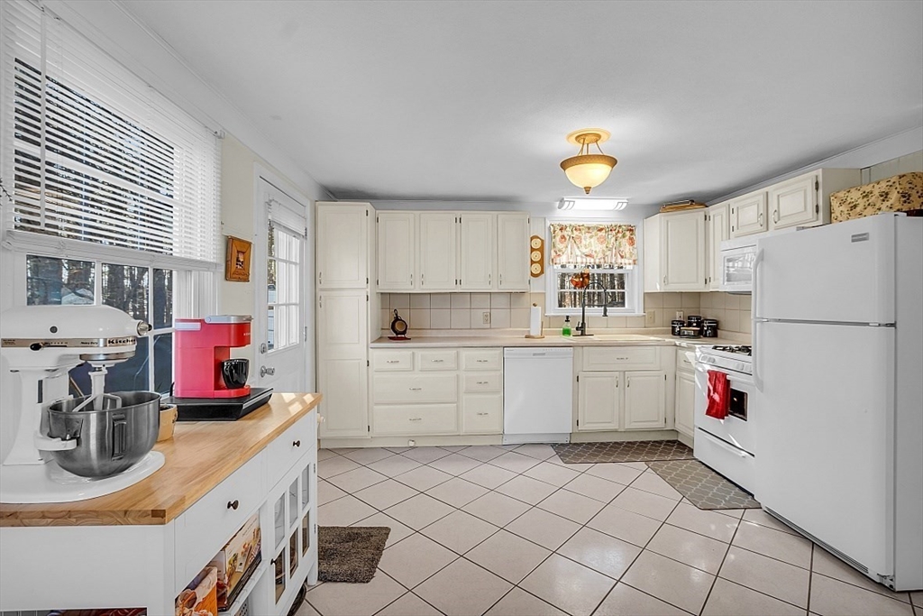 24 Edward Road Townsend, MA 01469 - Photo 14 of 38 a kitchen with a white refrigerator stove and white cabinets