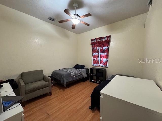 12140 Murray Avenue Largo, FL 33778 - Photo 17 of 23 a bedroom with furniture and a chandelier