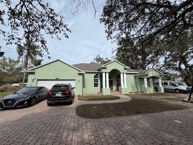 12140 Murray Avenue Largo, FL 33778 - Photo 21 of 23 a front view of a house with cars parked