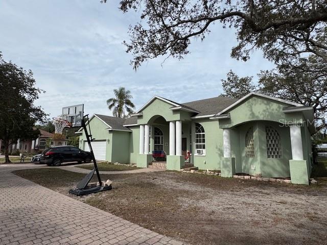 12140 Murray Avenue Largo, FL 33778 - Photo 22 of 23 a view of a white house with a large windows and a yard