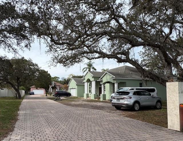 12140 Murray Avenue Largo, FL 33778 - Photo 23 of 23 a car parked in front of a white house