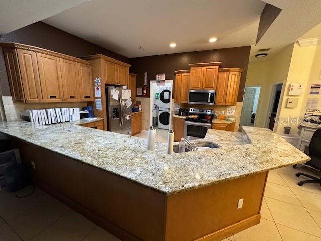 12140 Murray Avenue Largo, FL 33778 - Photo 6 of 23 a kitchen with kitchen island granite countertop a sink stove and refrigerator