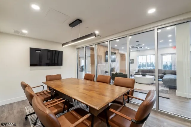 a living room with furniture a flat screen tv and a large window