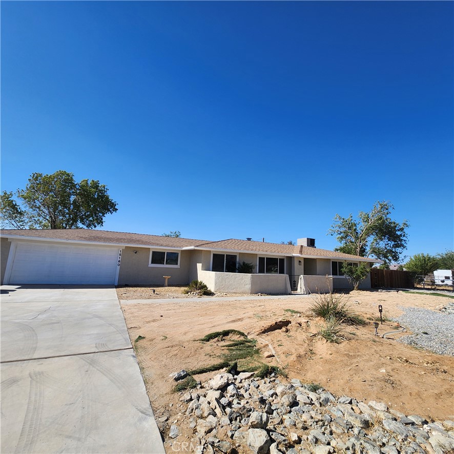 a view of swimming pool with a lawn chairs