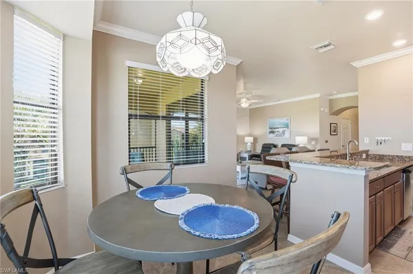 a view of a dining room with furniture wooden floor and chandelier