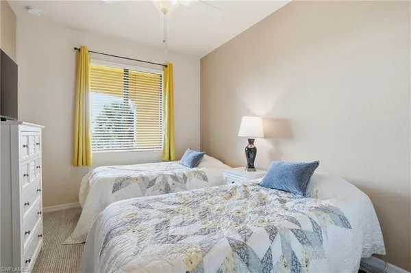 a bedroom with a bed and a lamp