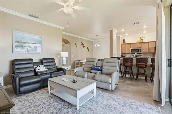 a living room with furniture and a chandelier