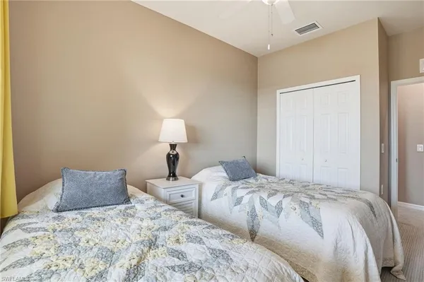 a bedroom with a bed and a lamp