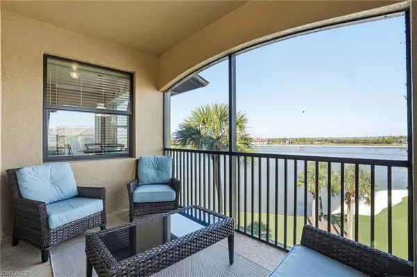 a balcony with couch and a potted plant