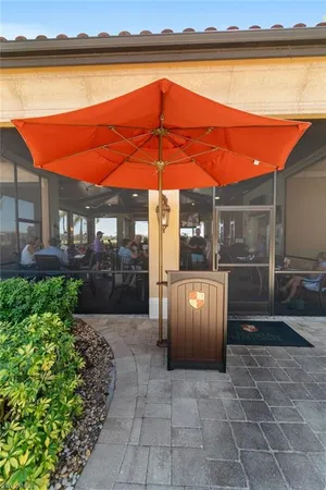 a view of a patio with a table and chairs under an umbrella