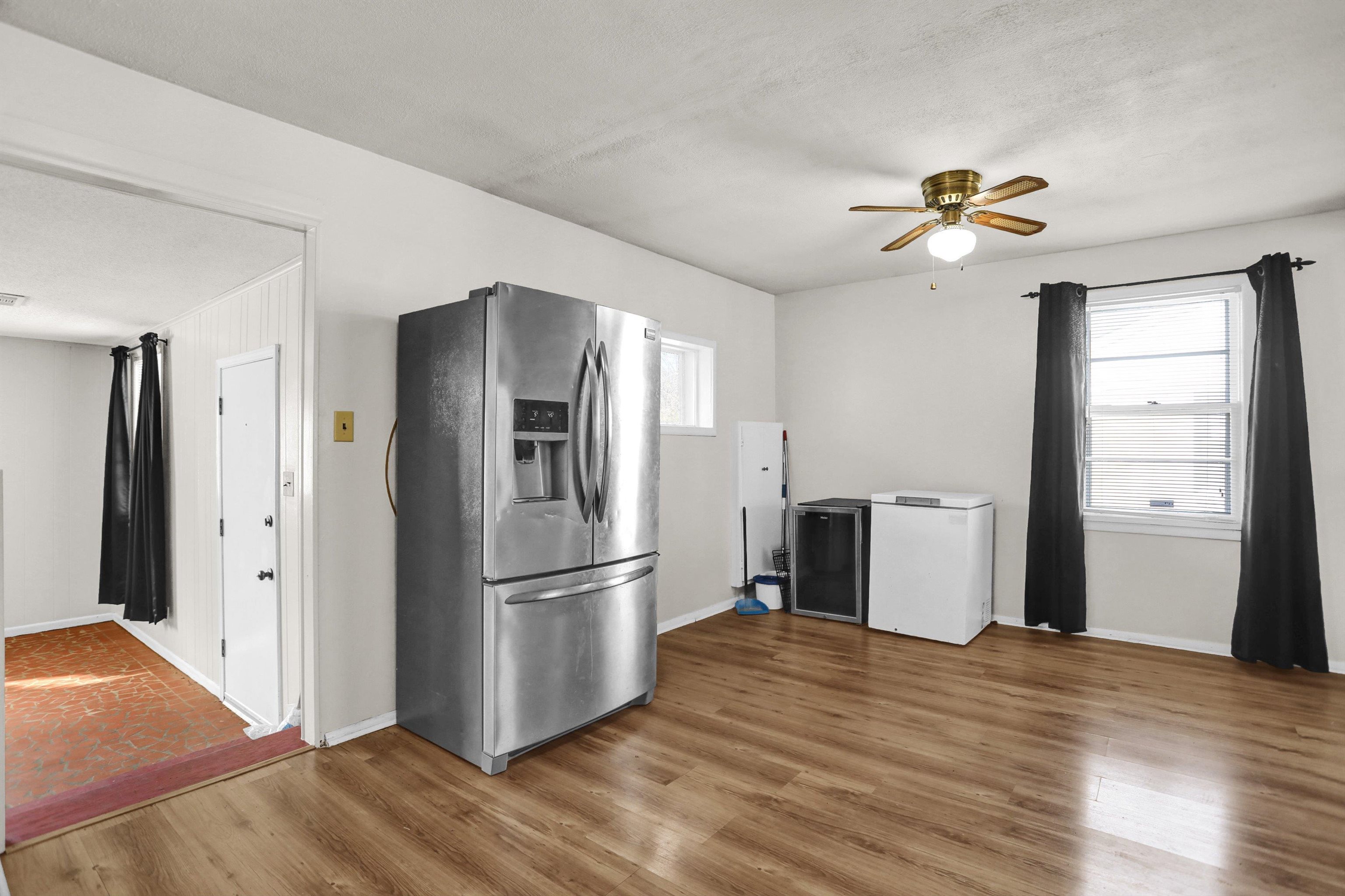 4931 Owen Road Memphis, TN 38122 - Photo 12 of 24 Kitchen with wood finished floors, fridge, stainless steel fridge, and a ceiling fan