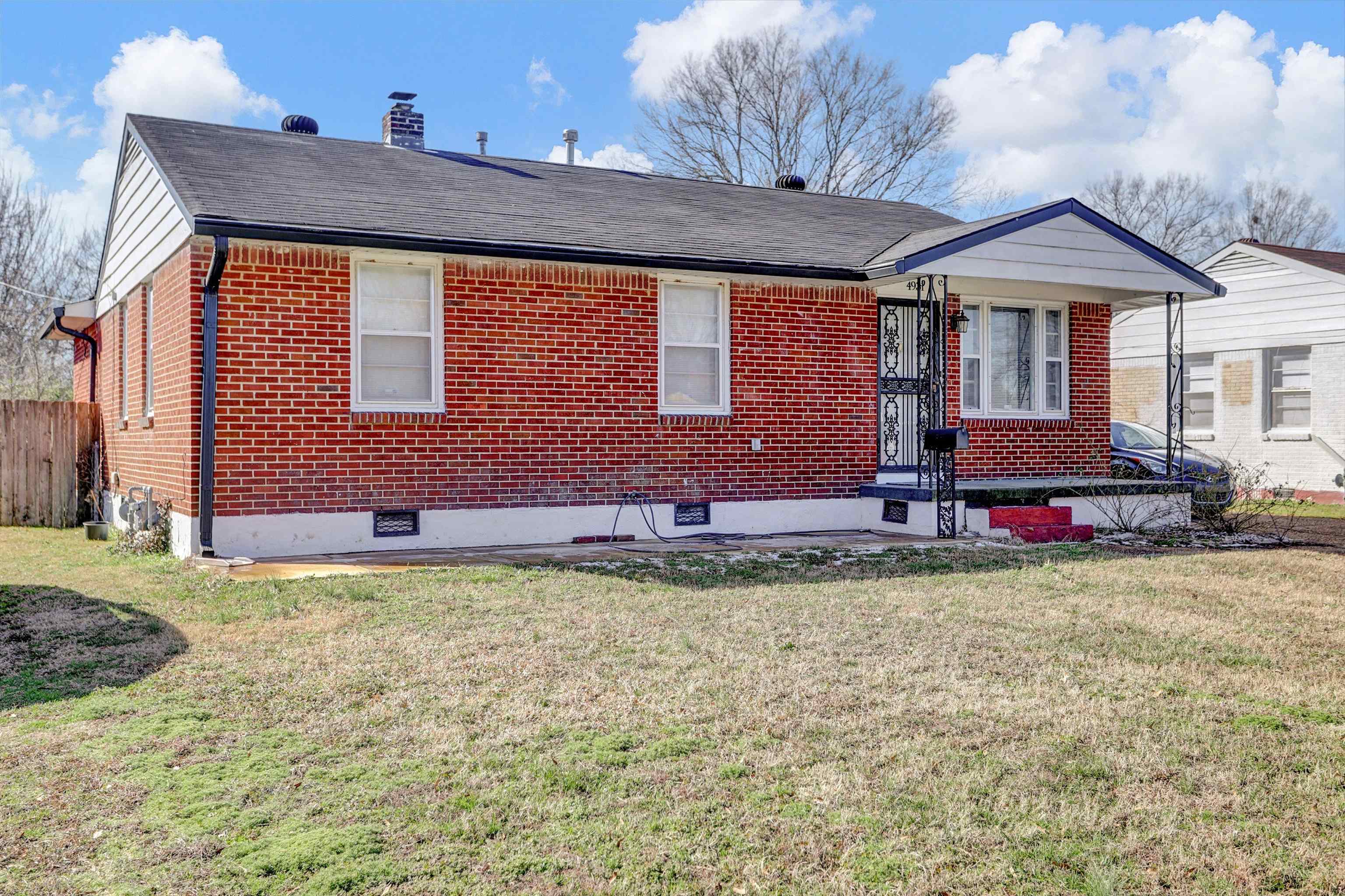 4931 Owen Road Memphis, TN 38122 - Photo 3 of 24 View of front of house featuring a front yard, a chimney, and brick siding