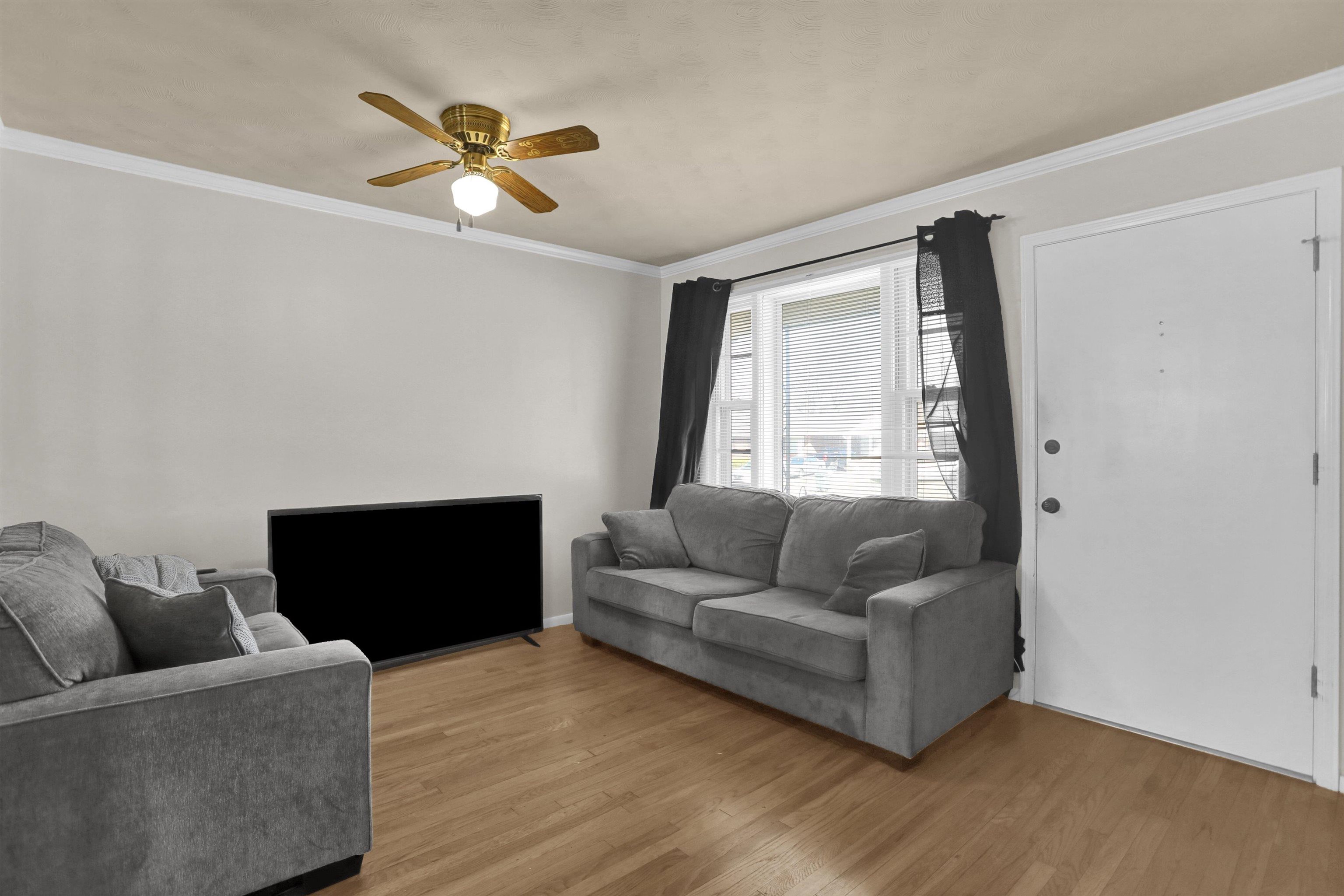 4931 Owen Road Memphis, TN 38122 - Photo 5 of 24 Living area featuring ceiling fan, ornamental molding, and wood finished floors