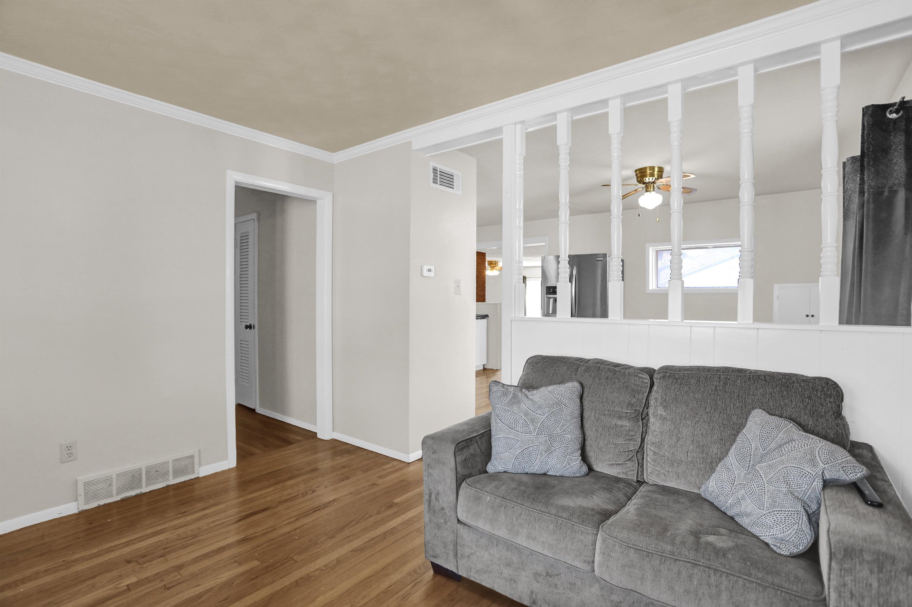 4931 Owen Road Memphis, TN 38122 - Photo 6 of 24 Living room with a ceiling fan, baseboards, visible vents, and wood finished floors