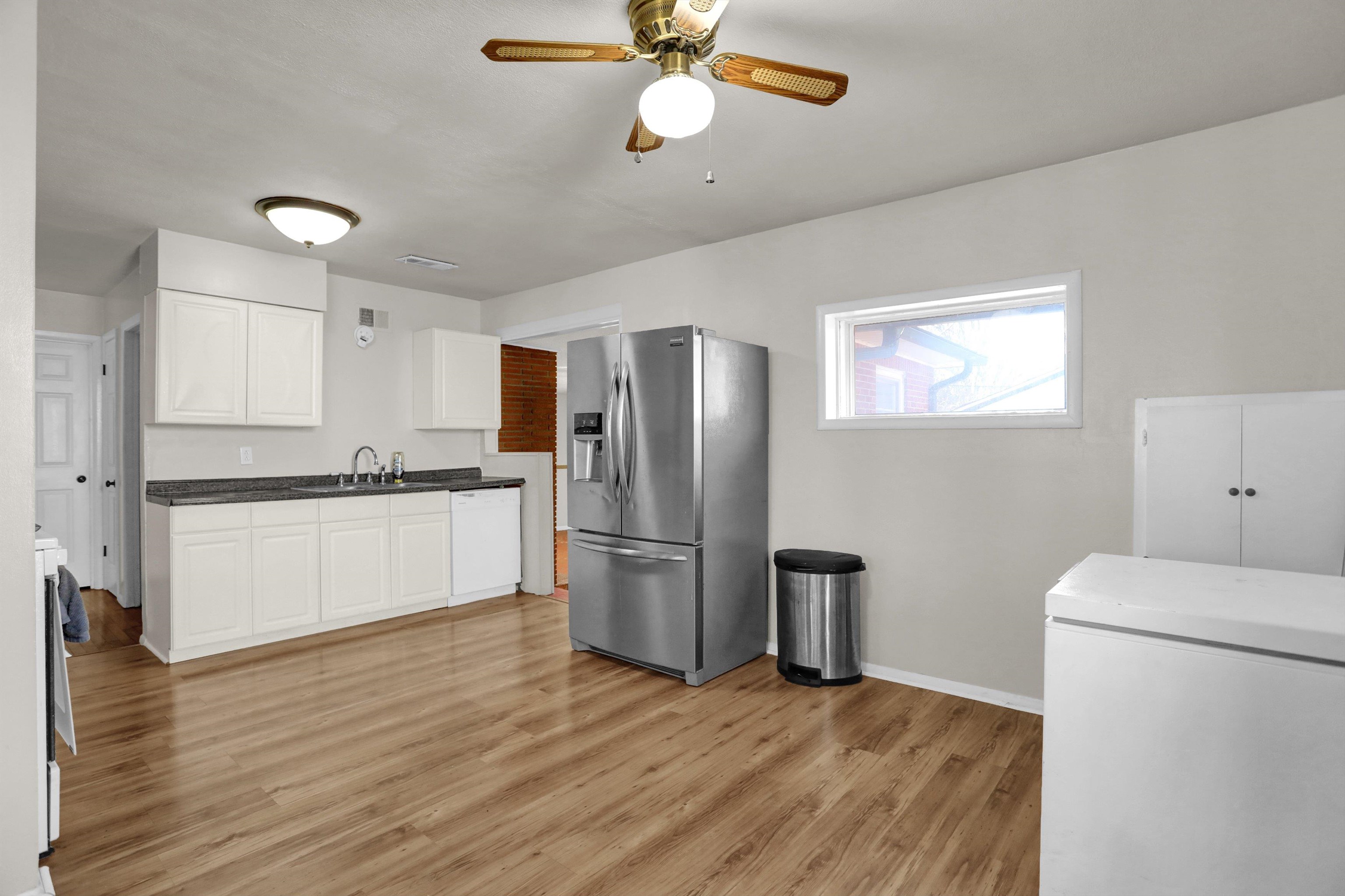 4931 Owen Road Memphis, TN 38122 - Photo 9 of 24 Kitchen with white dishwasher, refrigerator, a sink, white cabinets, and stainless steel refrigerator with ice dispenser