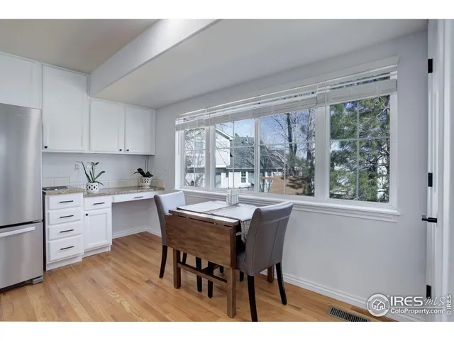 a kitchen with a table chairs and a window