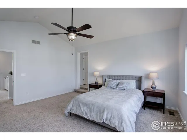 a bedroom with a bed and a lamp