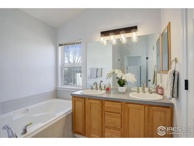 a bathroom with a bathtub sink and mirror