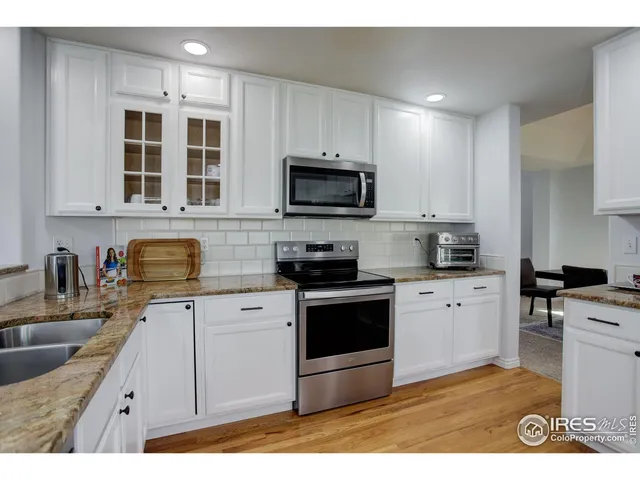 a kitchen with stainless steel appliances a stove sink microwave and cabinets