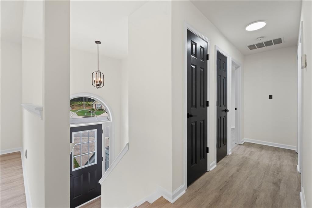 3602 Bristol Overlook Rex, GA 30273 - Photo 22 of 37 a view of hallway with stairs and wooden floor