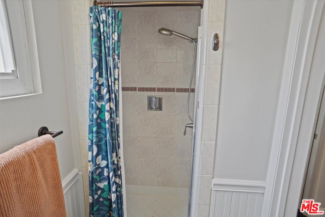 2400 Sylvan Lane Glendale, CA 91208 - Photo 12 of 28 a bathroom with a shower curtain and a window