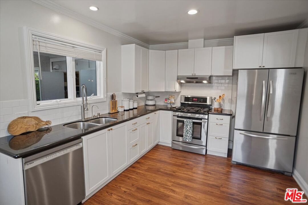 2400 Sylvan Lane Glendale, CA 91208 - Photo 7 of 28 a kitchen with granite countertop stainless steel appliances a sink and cabinets