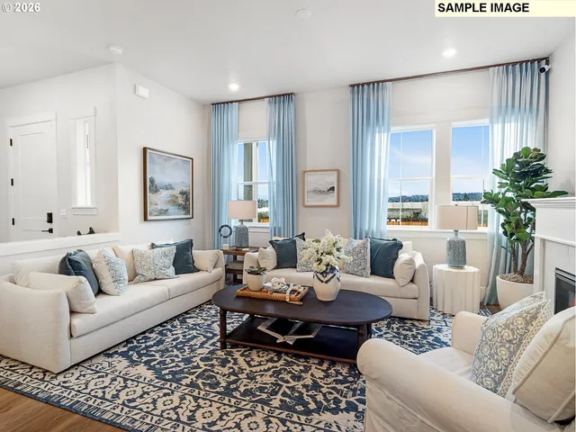 a living room with furniture potted plant and a window