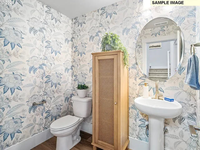 a bathroom with a sink and mirror with toilet