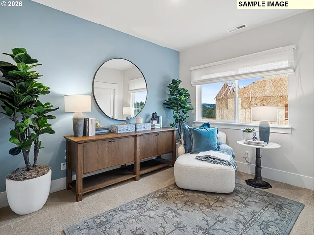 a living room with furniture a window and a potted plant