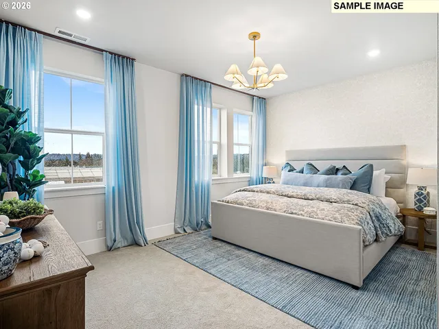 a spacious bedroom with a bed and a chandelier