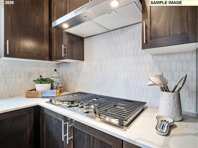 a kitchen with a stove and cabinets