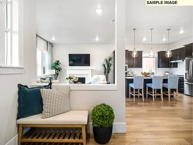 a living room with furniture a dining table and a potted plant