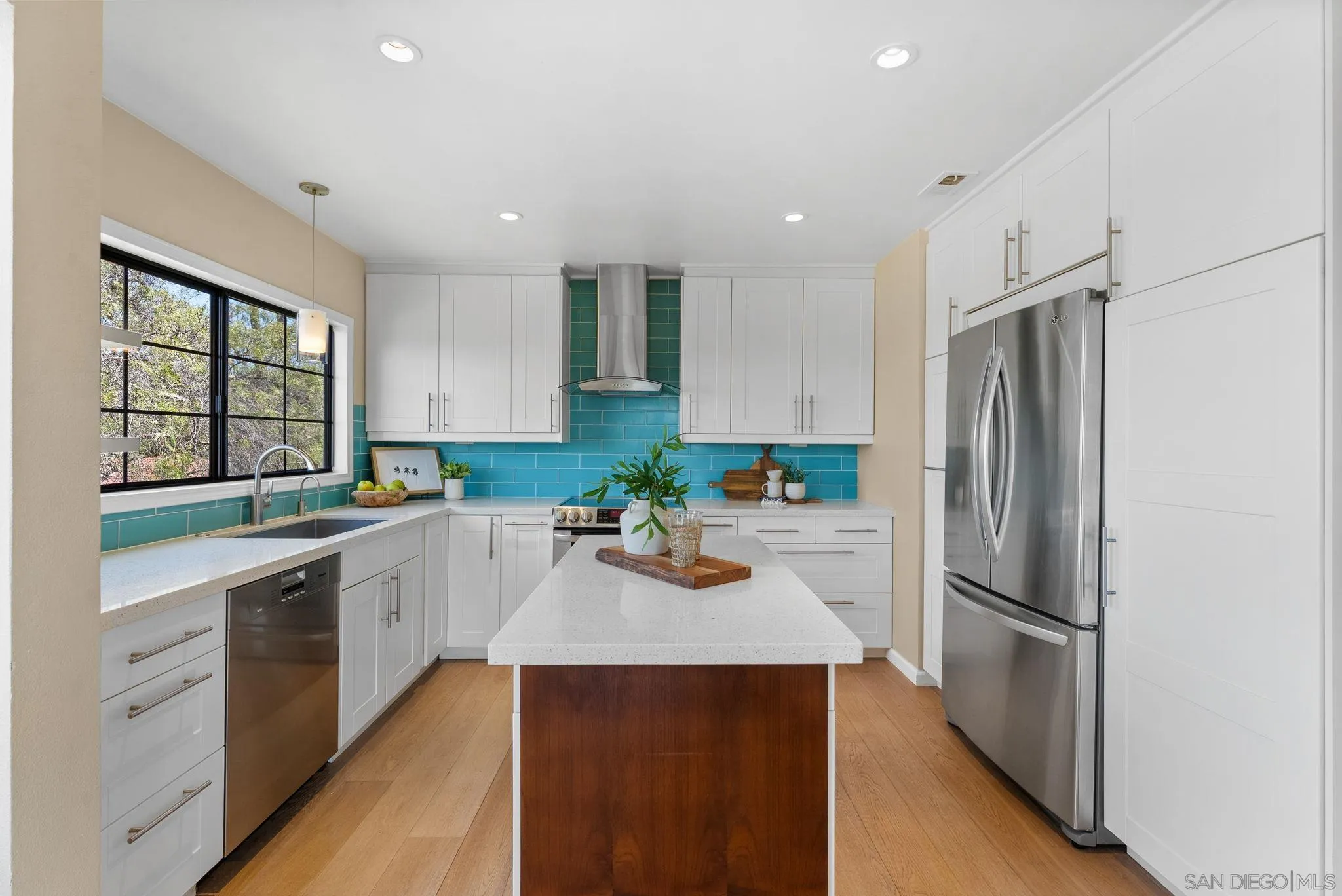 3127 Vista Rica Carlsbad, CA 92009 - Photo 7 of 25 a kitchen with a refrigerator sink and cabinets