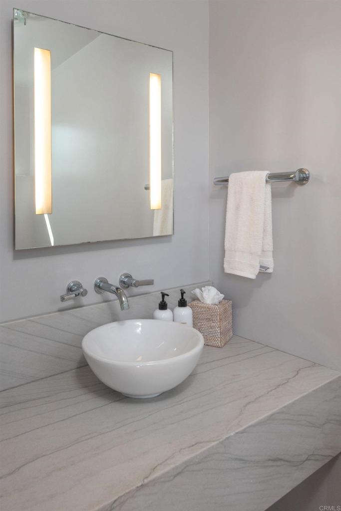 90 North Coast Highway 101, Unit 310 Encinitas, CA 92024 - Photo 11 of 24 a bathroom with a sink and a mirror