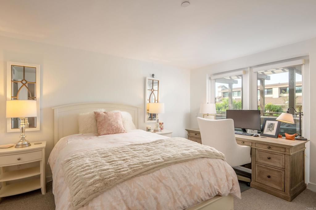 90 North Coast Highway 101, Unit 310 Encinitas, CA 92024 - Photo 15 of 24 a bedroom with a bed and large windows