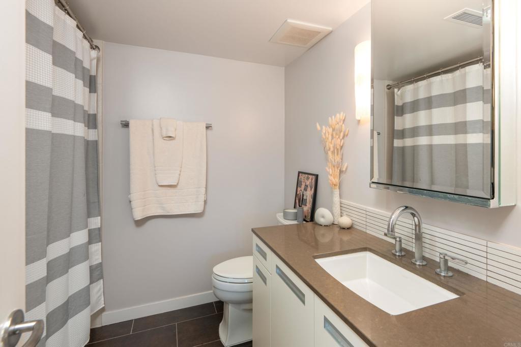 90 North Coast Highway 101, Unit 310 Encinitas, CA 92024 - Photo 17 of 24 a bathroom with a sink toilet and shower