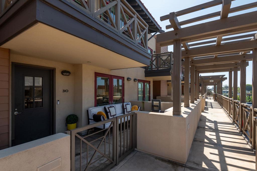 90 North Coast Highway 101, Unit 310 Encinitas, CA 92024 - Photo 22 of 24 a view of a patio with table and chairs