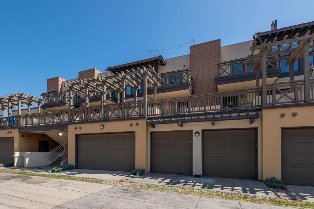 90 North Coast Highway 101, Unit 310 Encinitas, CA 92024 - Photo 23 of 24 a front view of a building with a yard and balcony