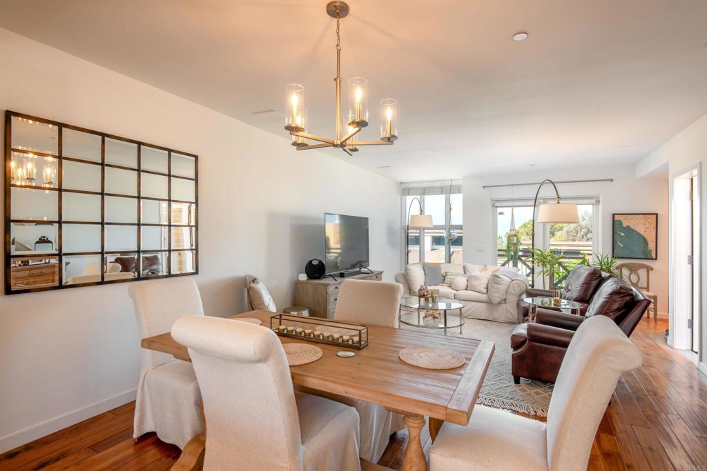 90 North Coast Highway 101, Unit 310 Encinitas, CA 92024 - Photo 3 of 24 a view of a dining room with furniture window and wooden floor