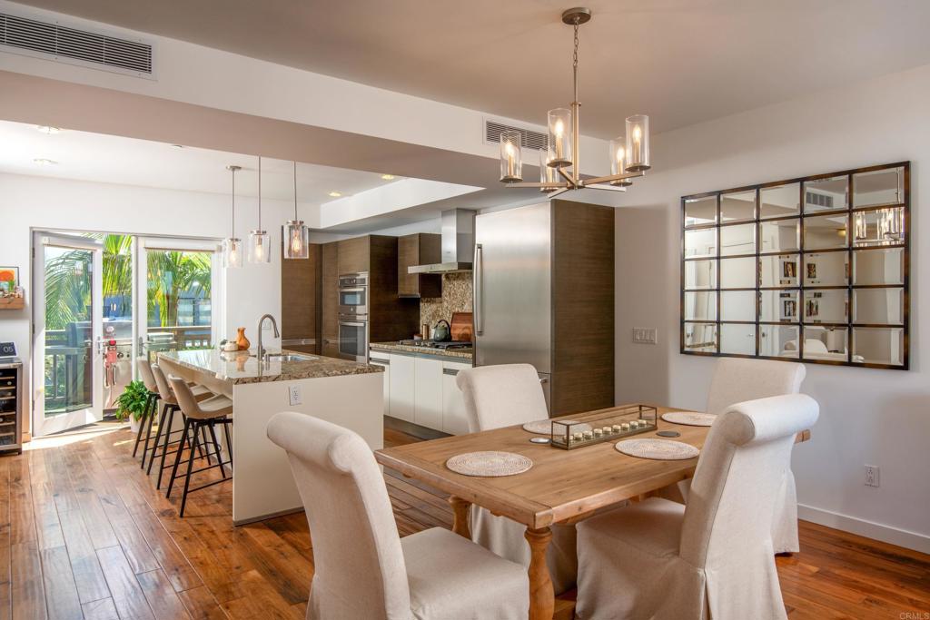 90 North Coast Highway 101, Unit 310 Encinitas, CA 92024 - Photo 8 of 24 a view of a dining room with furniture window and wooden floor