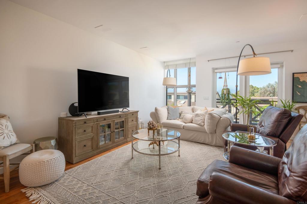 90 North Coast Highway 101, Unit 310 Encinitas, CA 92024 - Photo 9 of 24 a living room with furniture and a flat screen tv