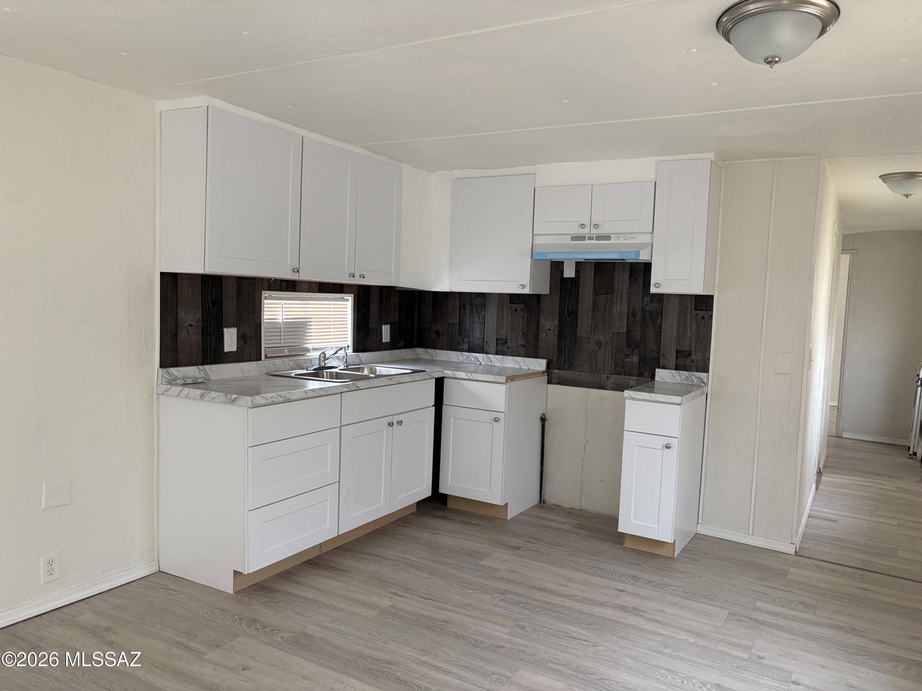 1741 West Wetmore Road, Unit 17 Tucson, AZ 85705 - Photo 4 of 9 a kitchen with appliances a sink and cabinets