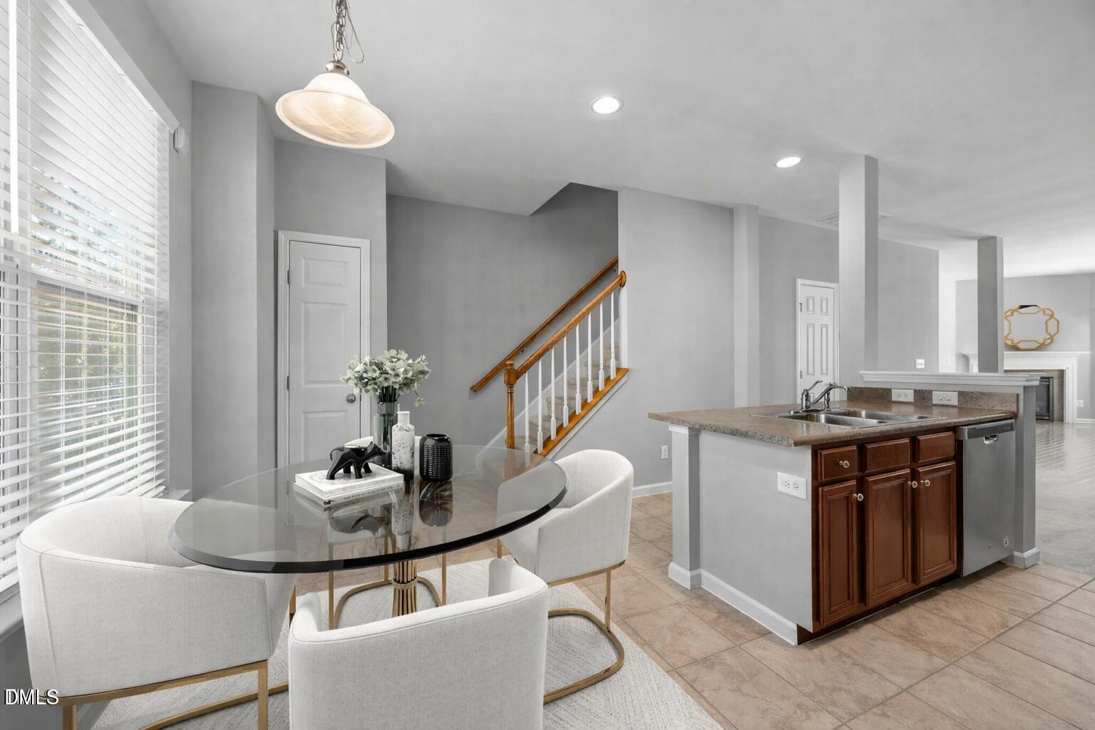 6626 Clarksburg Place Raleigh, NC 27616 - Photo 11 of 25 a kitchen with stainless steel appliances granite countertop a stove and a dining table