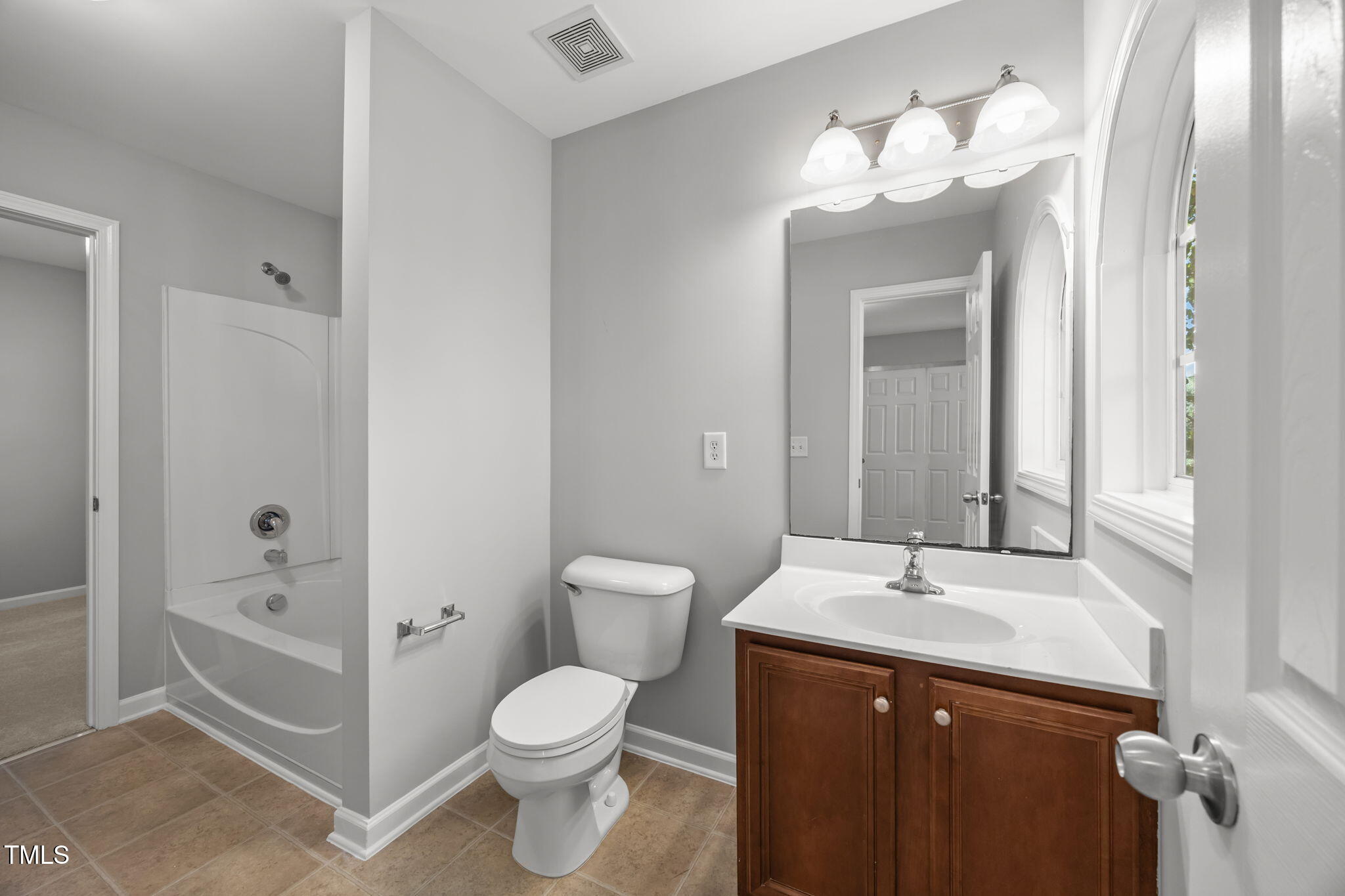 6626 Clarksburg Place Raleigh, NC 27616 - Photo 16 of 25 a bathroom with a sink toilet and shower